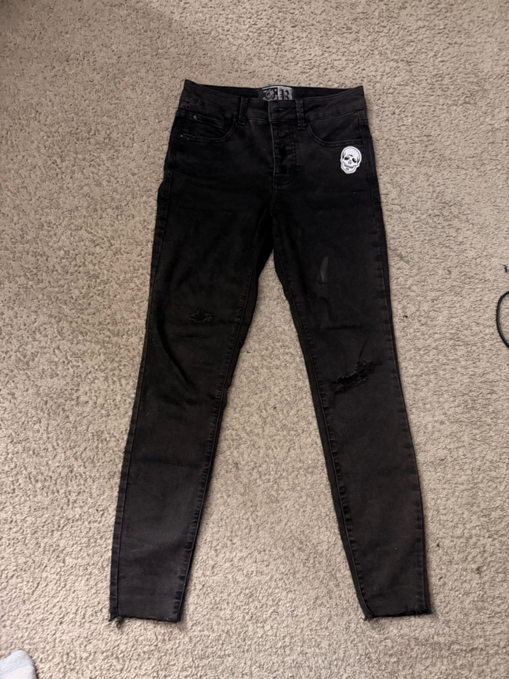Black Distressed Men’s Skinny Jeans with Skull Patch Accent